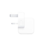 Apple 12W UK Adapter plugged into a wall socket, charging an iPad.