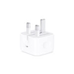 Apple 20W USB-C Power Adapter plugged into a wall outlet, charging an iPhone.